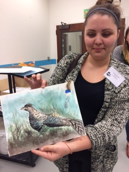 artist displaying pheasant painting