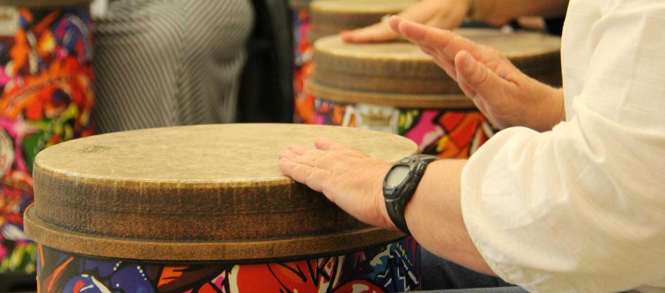 close up of musician's hands playing hand drum