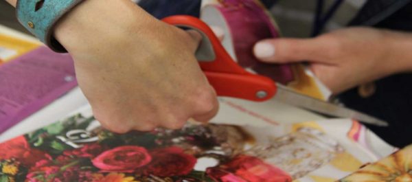 Close up of artist cutting fabric with scissors