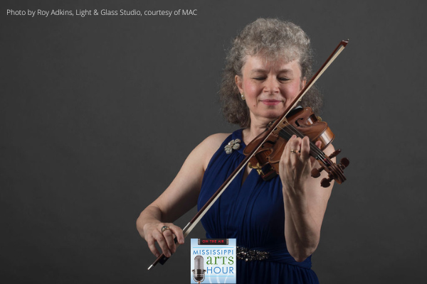 Marta Szlubowska playing a violin with a MS Arts hour logo at the bottom of the image.