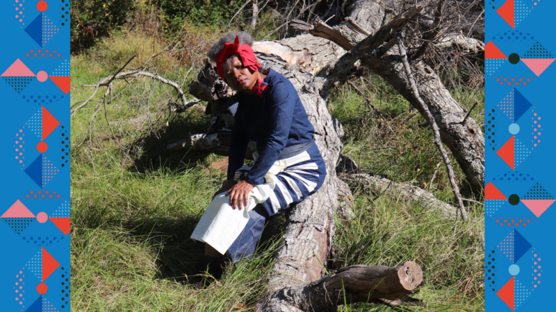 Dr. J. Janice Coleman sitting on a fallen tree in an overgrown field